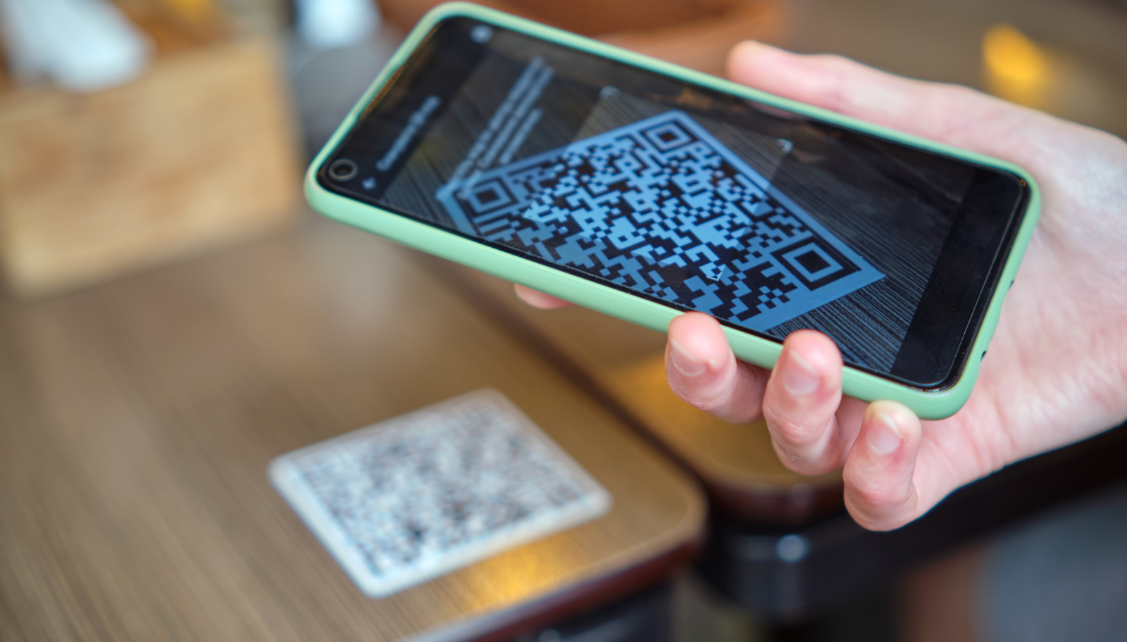 Guest scanning a QR code card with a phone to open a chat