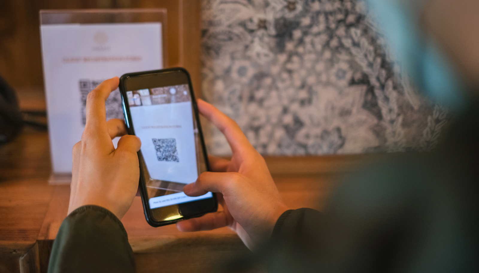 Guest scanning a QR code on a welcome card to reach the AI host
